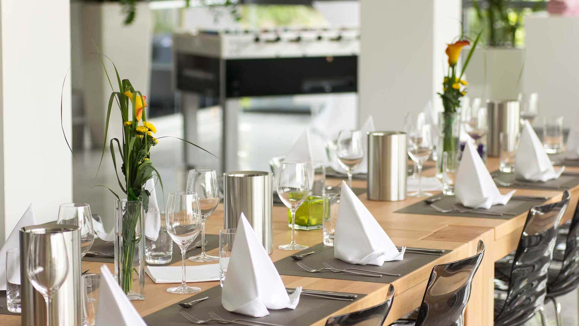 Eingedeckte Tische für ein gemeinsames Mahl im Kochkurs des Kochatelier Bergisch Gladbach.